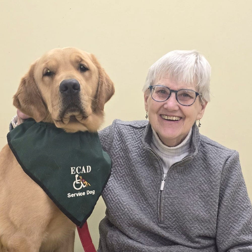 Shirley, an ECAD graduate, with her service dog Bonito (Bo).