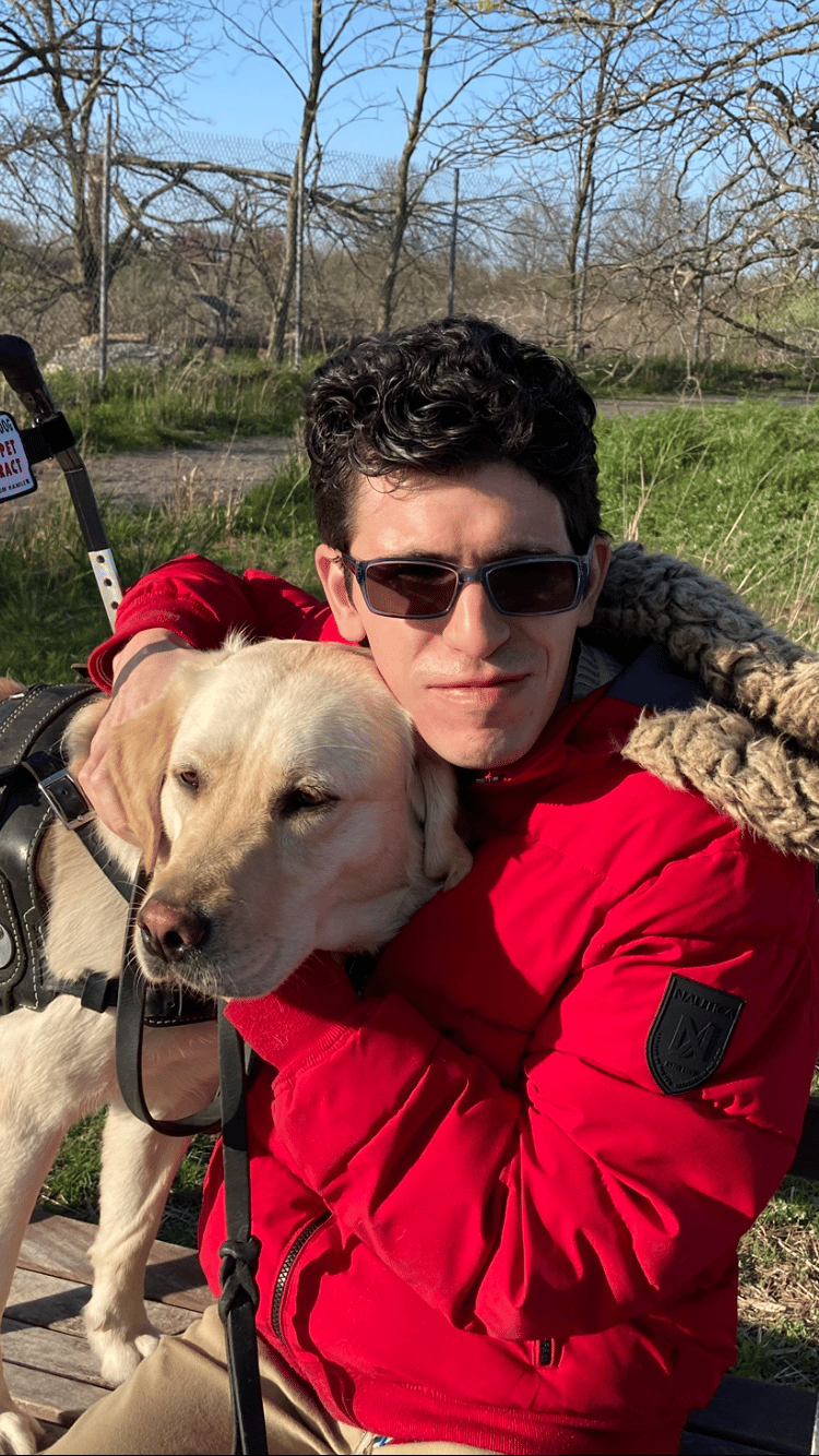 Anthony, an ECAD graduate, with his service dog Libby.