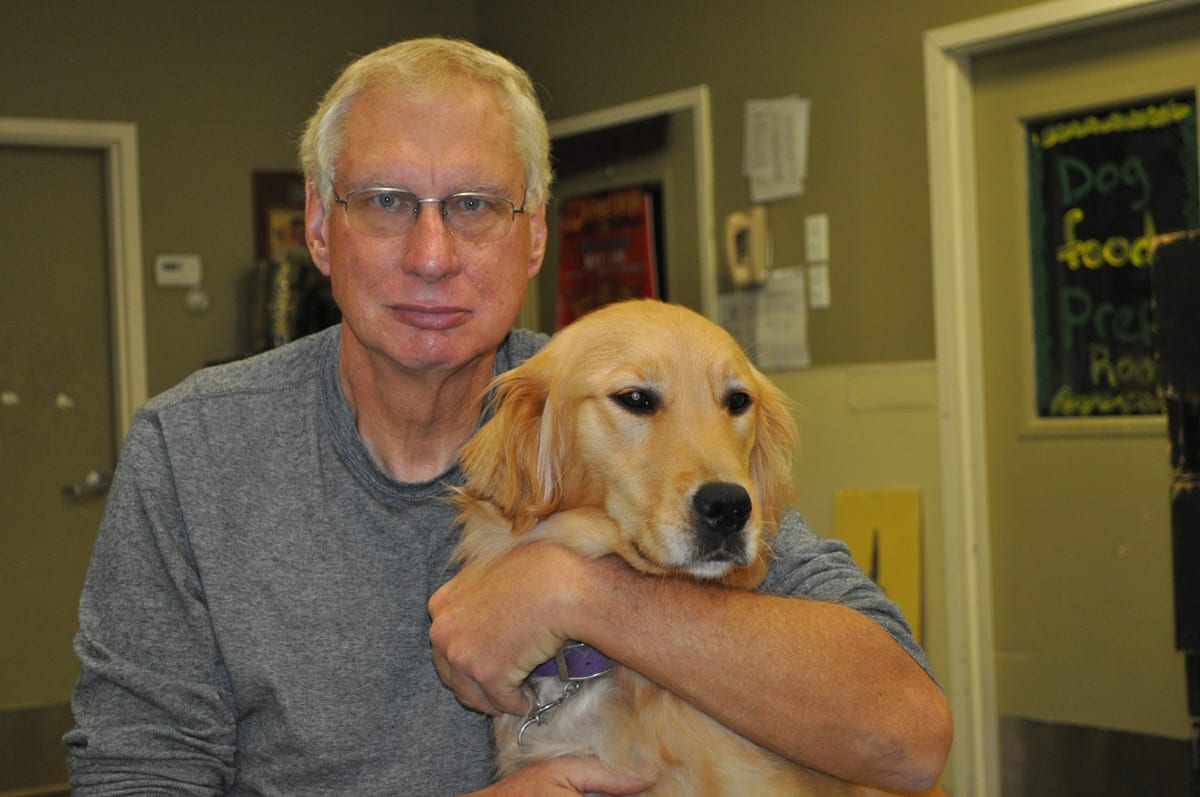 Ralph, a U.S. Army veteran and ECAD graduate, with his service dog Honey.