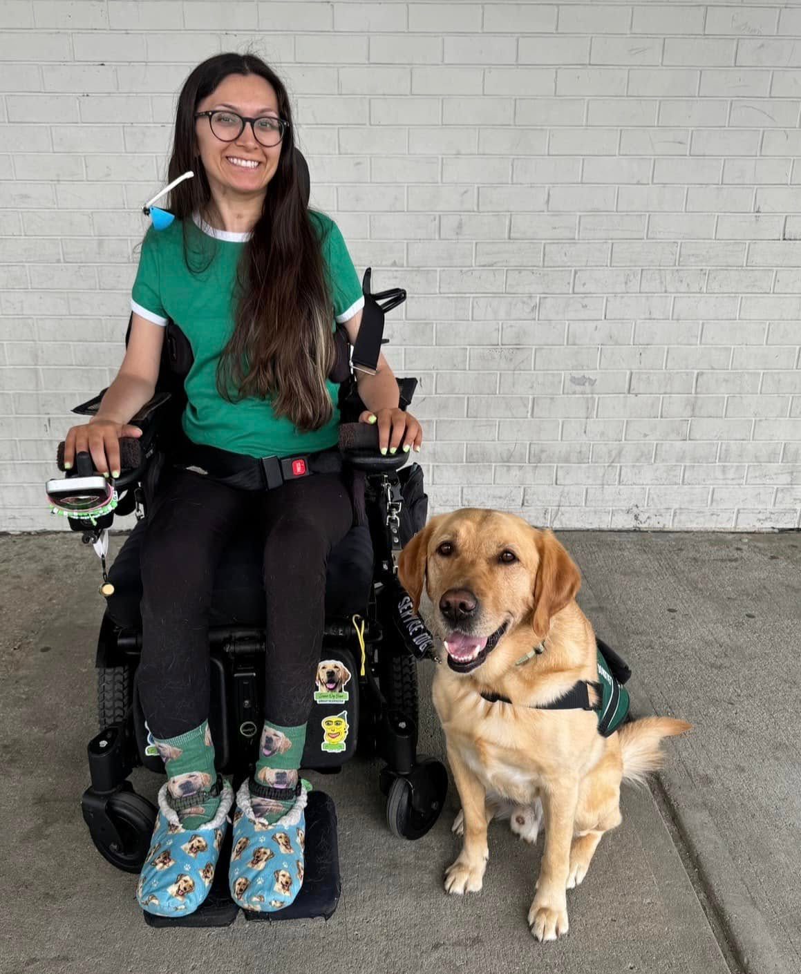 Gabby, an ECAD graduate, with her service dog Bravo.